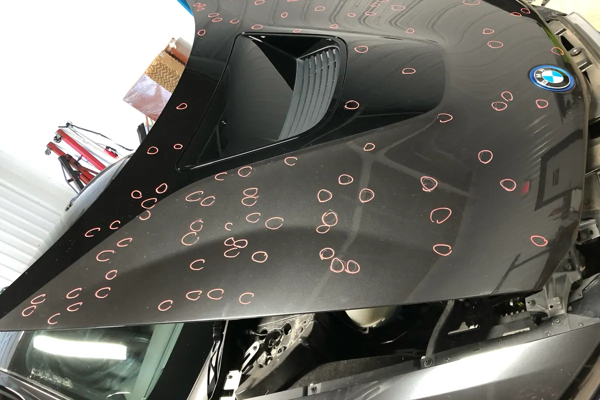 BMW hood documented with hail damage marks