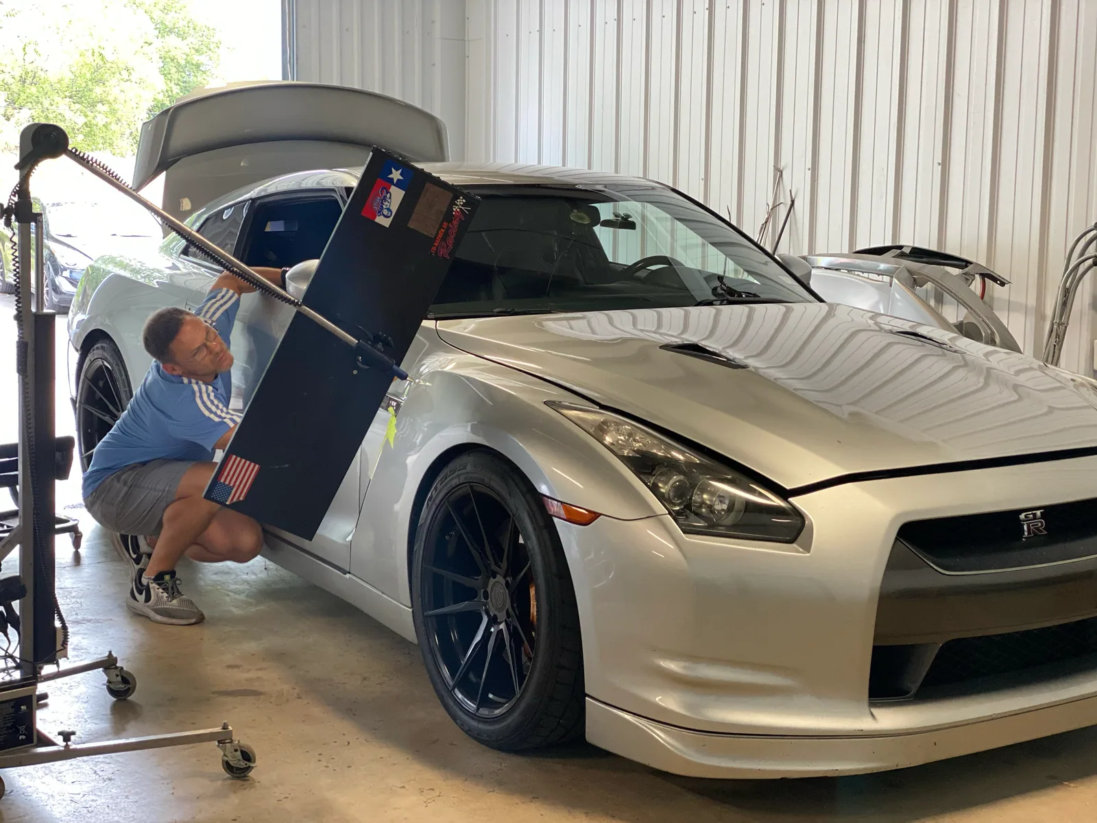 5Star technician performing precision paintless dent repair on a Nissan GT-R
