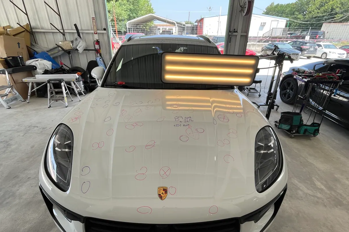 Porsche hood marked for precision dent repair